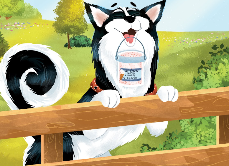 Jonathan the Husky holding a bucket of UConn Husky treats by a wooden fence